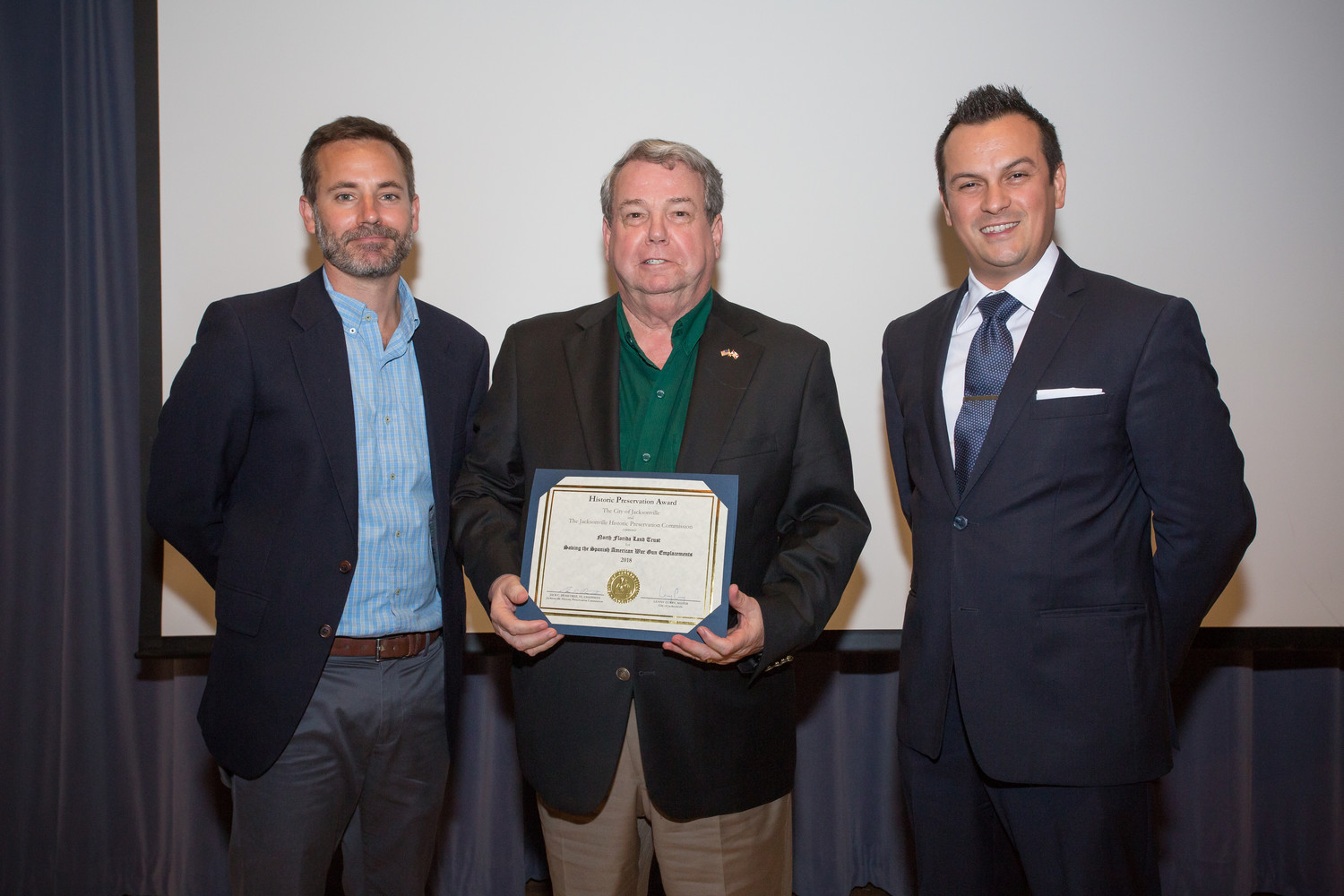 North Florida Land Trust President and Ponte Vedra resident Jim McCarthy (center) is presented with the 2018 Historic Preservation Award by Jacksonville Historic Preservation Commission Vice Chairman Ryan Davis (from left) and Commissioner Andres Lopera.